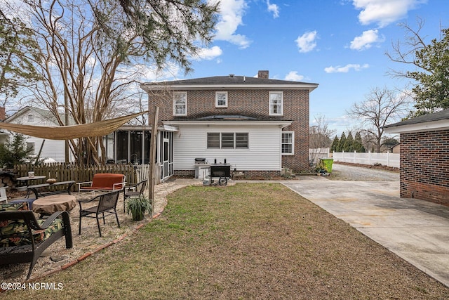 back of house with a patio and a yard