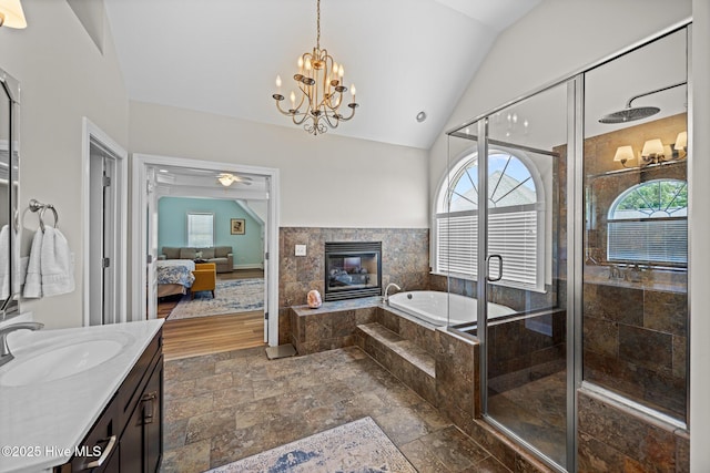4441 Lagan Cir, Winterville, NC 28590 - ensuite bathroom with plenty of natural light, vanity, vaulted ceiling, a garden tub, and a fireplace
