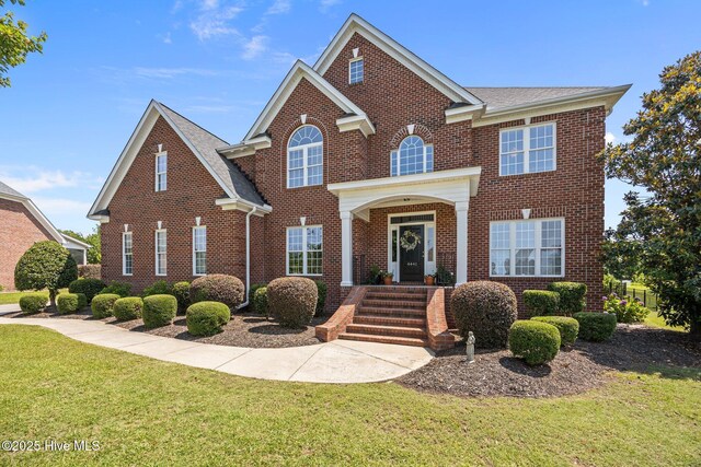 4441 Lagan Cir, Winterville, NC 28590 - view of front of home with brick siding, a front lawn, and a shingled roof