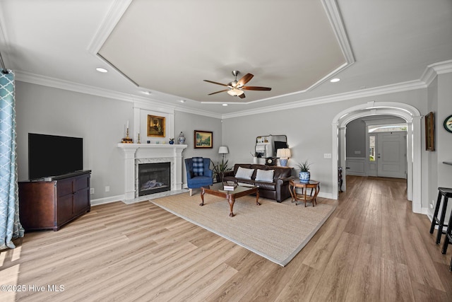 4441 Lagan Cir, Winterville, NC 28590 - living room featuring a ceiling fan, recessed lighting, light wood-style flooring, arched walkways, and a fireplace
