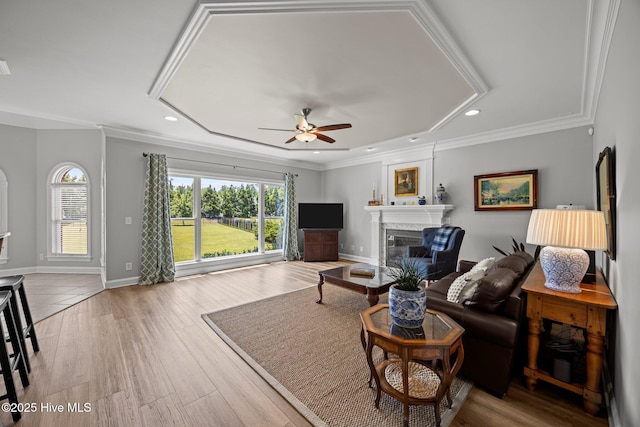 4441 Lagan Cir, Winterville, NC 28590 - living area with a ceiling fan, a glass covered fireplace, recessed lighting, ornamental molding, and wood finished floors