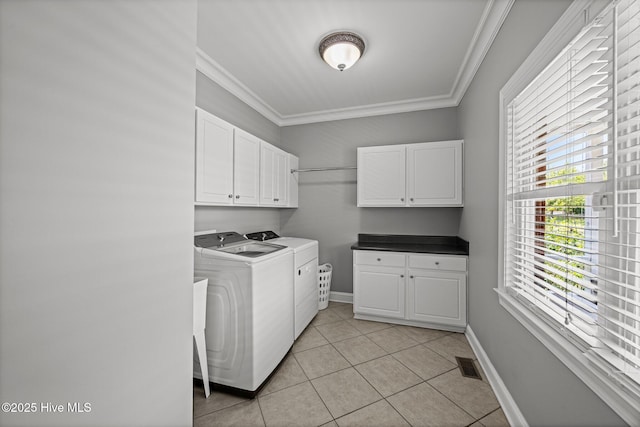 4441 Lagan Cir, Winterville, NC 28590 - laundry room with washing machine and dryer, cabinet space, crown molding, light tile patterned floors, and baseboards