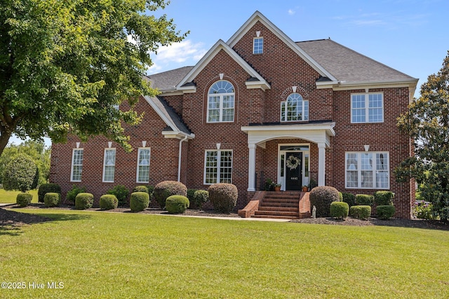4441 Lagan Cir, Winterville, NC 28590 - georgian-style home with brick siding, a front lawn, and a shingled roof