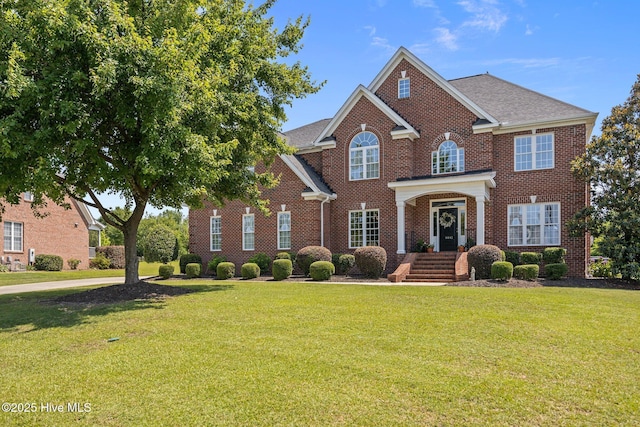 4441 Lagan Cir, Winterville, NC 28590 - colonial-style house featuring brick siding, a front lawn, and a shingled roof