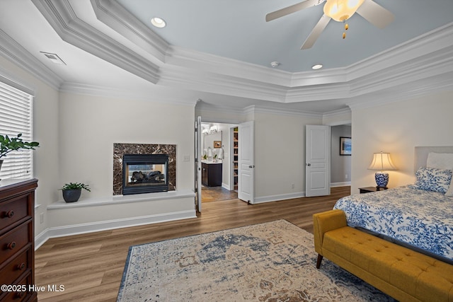 4441 Lagan Cir, Winterville, NC 28590 - bedroom featuring a tray ceiling, wood finished floors, a premium fireplace, crown molding, and baseboards