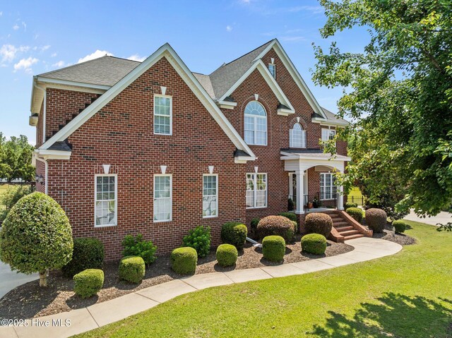 4441 Lagan Cir, Winterville, NC 28590 - colonial inspired home featuring brick siding, a front lawn, and roof with shingles