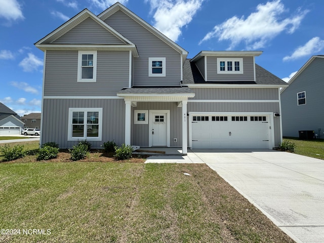 view of front of property with a garage and a front yard