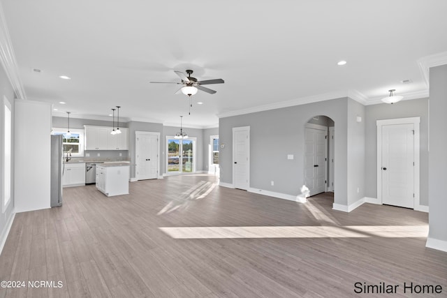 unfurnished living room featuring ceiling fan, light wood-type flooring, and ornamental molding