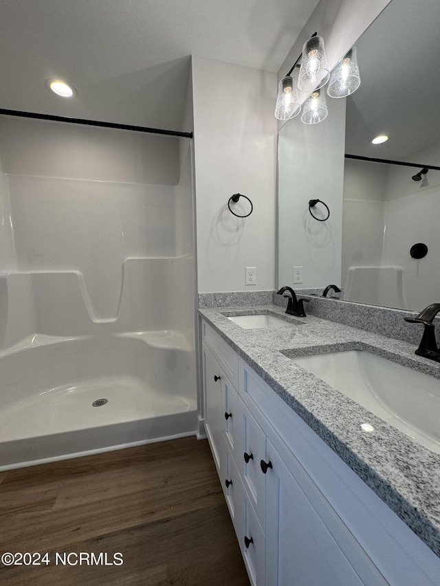 401 Bay Harbor Ct, Hubert, NC 28539 - full bathroom with walk in shower, double vanity, a sink, and wood finished floors