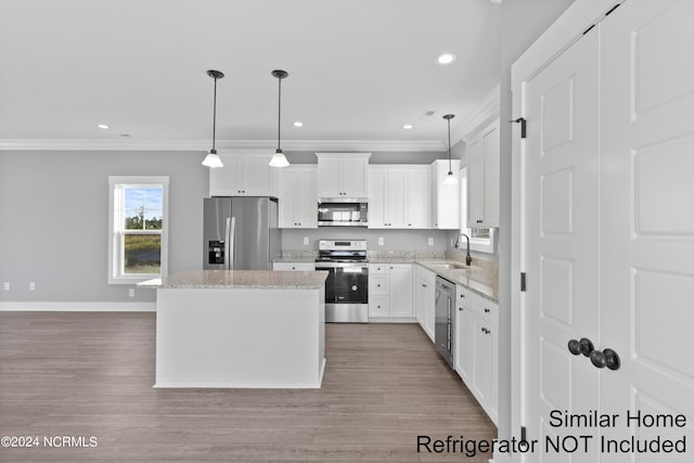 kitchen featuring white cabinetry, a center island, light hardwood / wood-style flooring, and appliances with stainless steel finishes