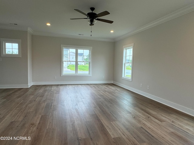 unfurnished room featuring ornamental molding, wood-type flooring, and a healthy amount of sunlight