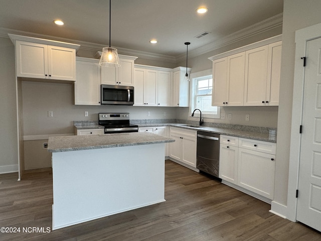 401 Bay Harbor Ct, Hubert, NC 28539 - kitchen with a sink, stainless steel appliances, ornamental molding, white cabinets, and a kitchen island