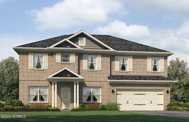 view of front of home with a garage and a front yard