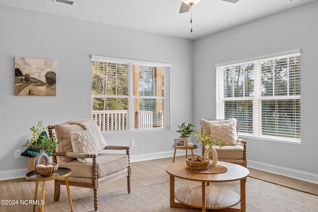 living area featuring ceiling fan and light hardwood / wood-style floors