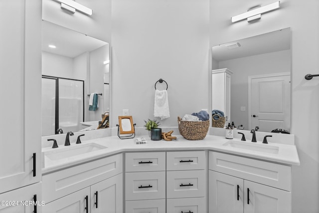 bathroom featuring vanity and a shower with shower door