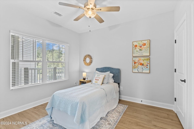 bedroom with wood-type flooring and ceiling fan