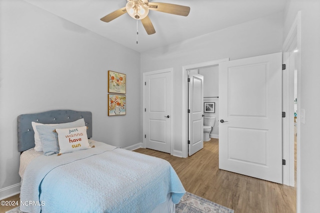 bedroom featuring ceiling fan, light wood-type flooring, and ensuite bath