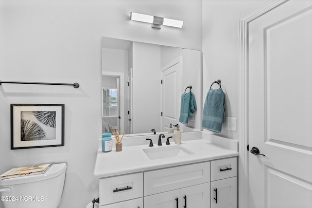 bathroom with vanity and toilet