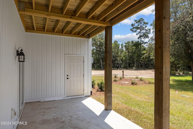 doorway to property featuring a patio area and a yard