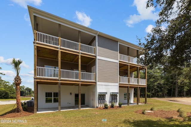 back of property with a yard and a patio