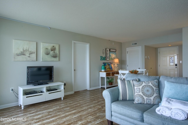 2000 New River Inlet Rd Unit 3309, North Topsail Beach, NC 28460 - living room with light hardwood / wood-style floors and a textured ceiling