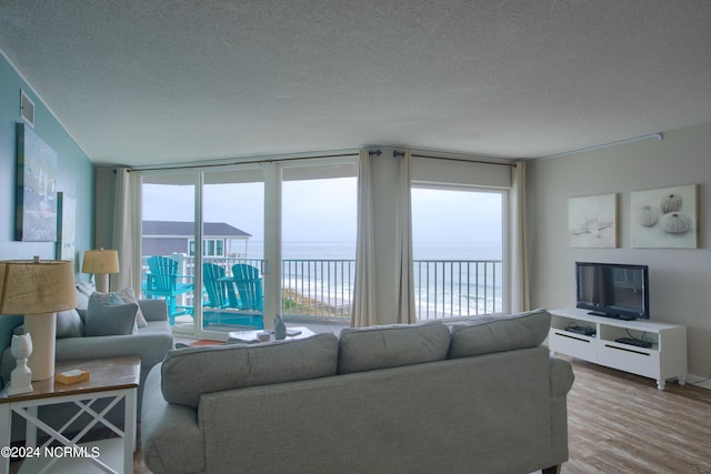 2000 New River Inlet Rd Unit 3309, North Topsail Beach, NC 28460 - living room with a textured ceiling, light hardwood / wood-style floors, and a water view