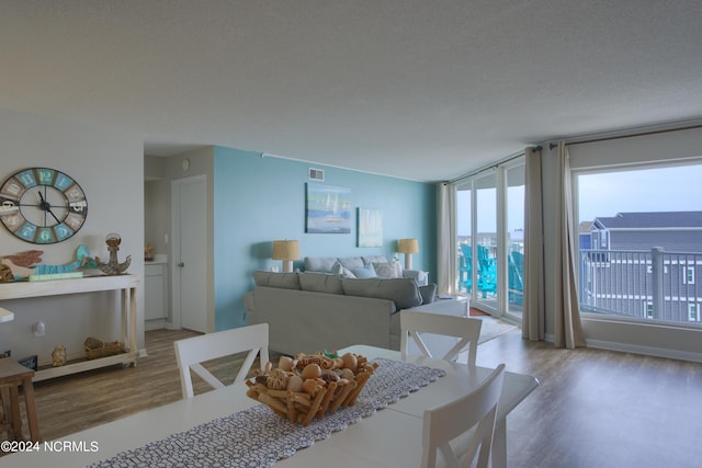 2000 New River Inlet Rd Unit 3309, North Topsail Beach, NC 28460 - dining space with a textured ceiling, light hardwood / wood-style floors, and a healthy amount of sunlight