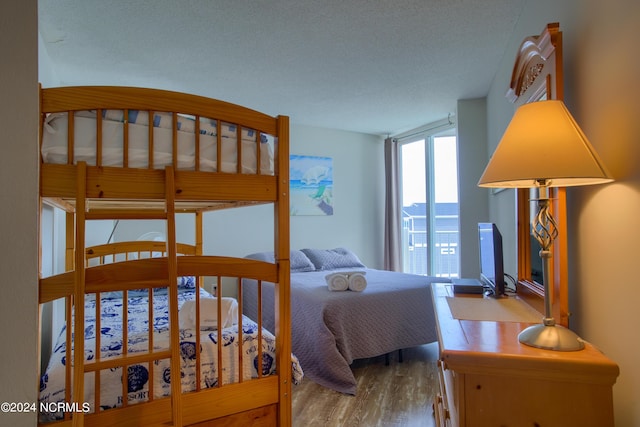 2000 New River Inlet Rd Unit 3309, North Topsail Beach, NC 28460 - bedroom featuring hardwood / wood-style floors and a textured ceiling