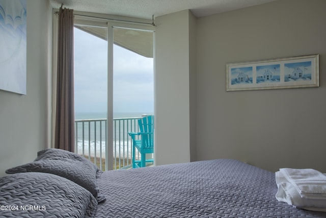 2000 New River Inlet Rd Unit 3309, North Topsail Beach, NC 28460 - bedroom with a water view, a textured ceiling, and access to exterior