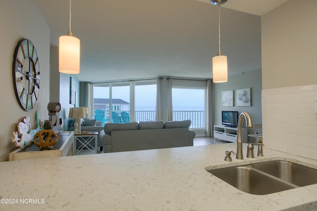 2000 New River Inlet Rd Unit 3309, North Topsail Beach, NC 28460 - kitchen featuring hardwood / wood-style flooring, light stone counters, sink, and pendant lighting