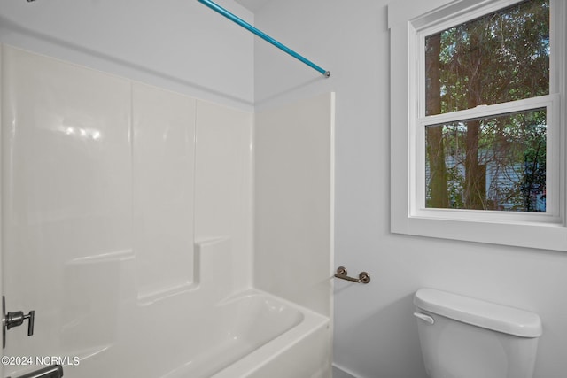 bathroom with tub / shower combination and toilet