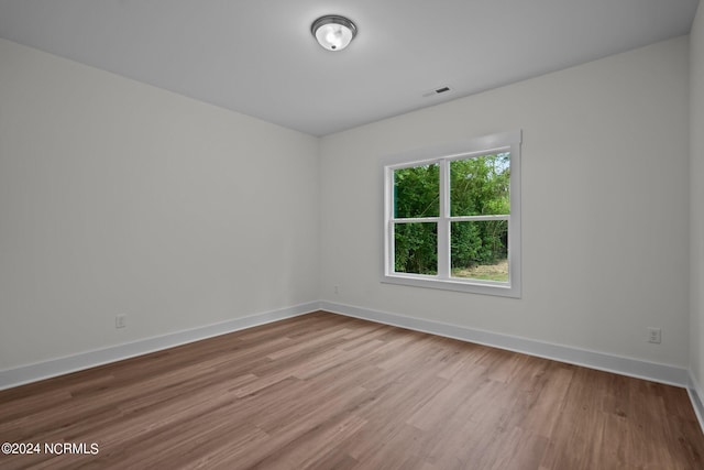 spare room with light hardwood / wood-style flooring