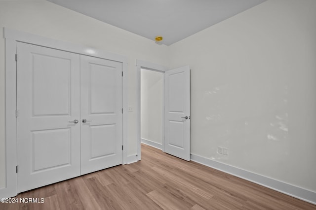 607 N Timberly Ln, Burgaw, NC 28425 - unfurnished bedroom featuring light wood-type flooring, baseboards, and a closet