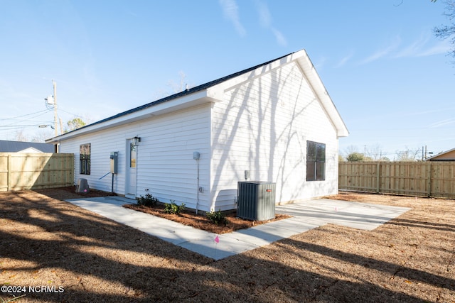 rear view of house with a patio area and cooling unit