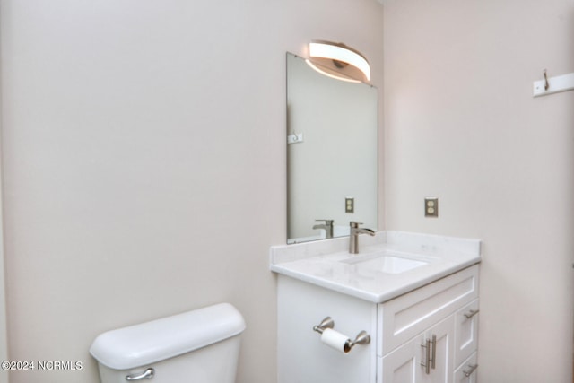 bathroom featuring oversized vanity and toilet