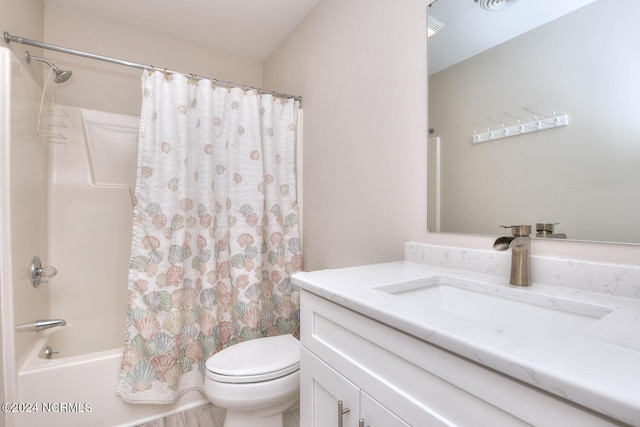 full bathroom featuring toilet, shower / tub combo, and vanity with extensive cabinet space