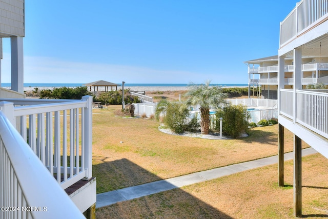 view of yard with a balcony and a water view