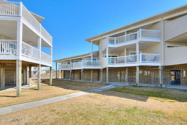 exterior space featuring a wooden deck and a lawn