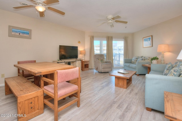 living room featuring light hardwood / wood-style floors and ceiling fan