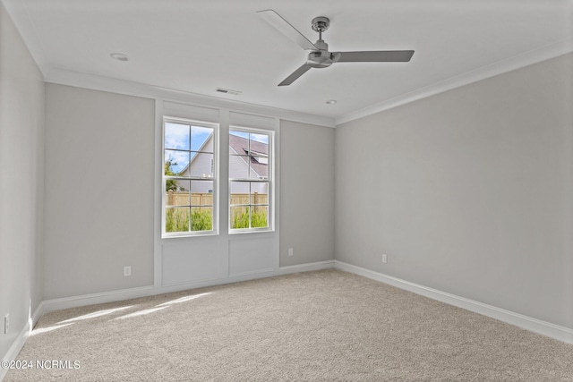 unfurnished room with a healthy amount of sunlight, ornamental molding, carpet floors, and ceiling fan