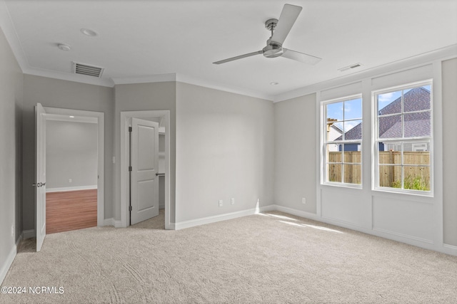 unfurnished bedroom featuring crown molding, ceiling fan, and light colored carpet