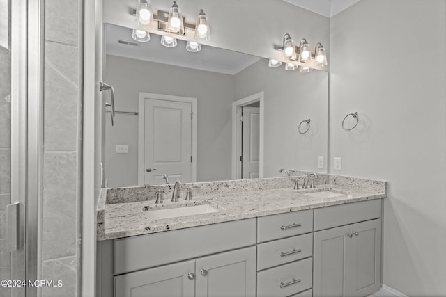 bathroom featuring ornamental molding, oversized vanity, and double sink