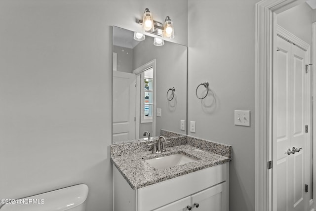 bathroom featuring large vanity and toilet