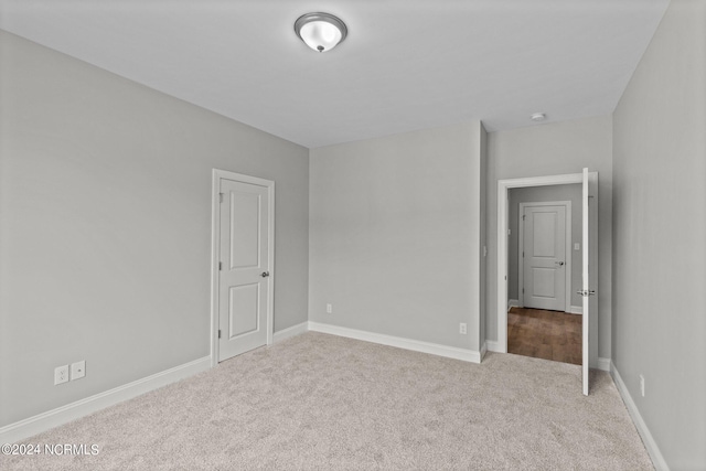 empty room featuring light carpet