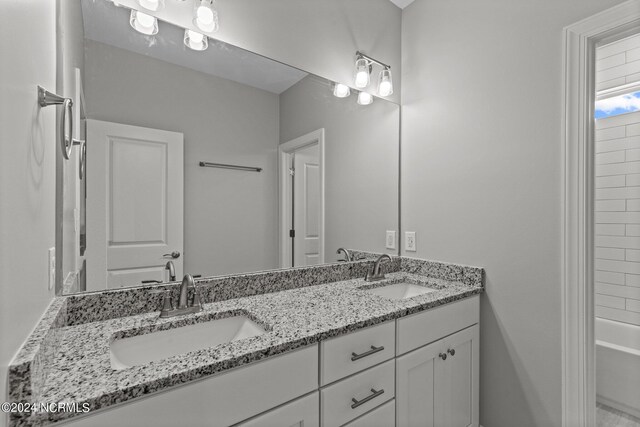 bathroom featuring vanity and shower / tub combination