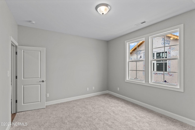 spare room with light colored carpet and plenty of natural light