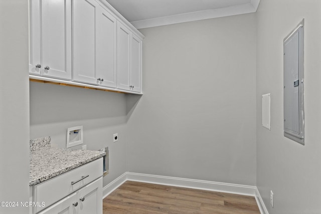 laundry area with crown molding, electric dryer hookup, hookup for a washing machine, electric panel, and cabinets