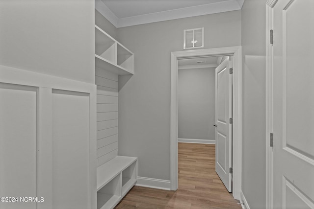 mudroom featuring light hardwood / wood-style flooring and crown molding