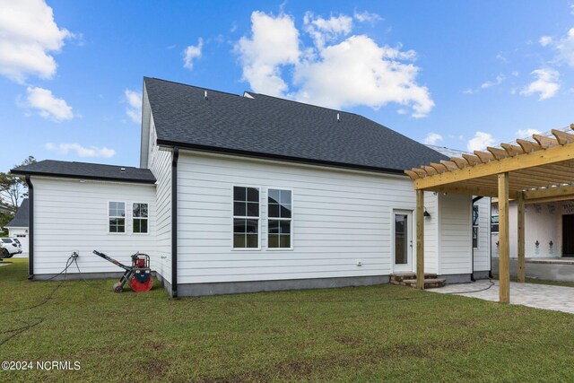 rear view of house featuring a pergola, a patio area, and a yard