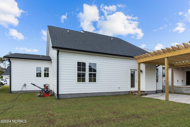 rear view of property with a yard, a pergola, and a patio area